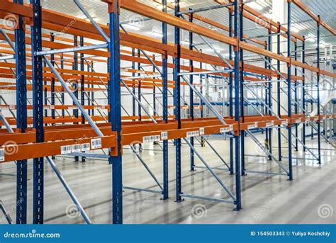 Blue And Orange Empty Warehouse Shelves In Grey Industrial Interior