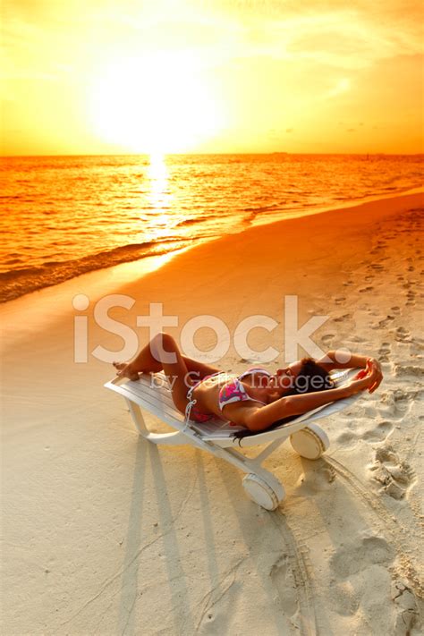 Woman In Chaise Lounge Relaxing On Beach Stock Photo Royalty Free FreeImages