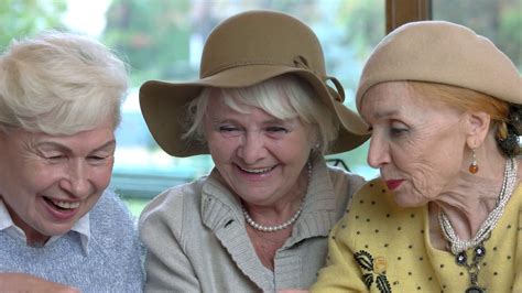 Cheerful women with a tablet. Old ladies smiling and talking. Stock Video Footage - Storyblocks
