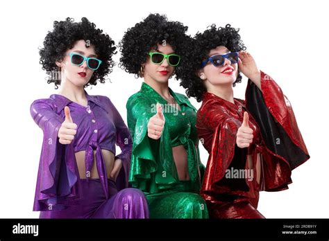 Disco Style Girls In Colorful Flared Suits And African American Wigs On