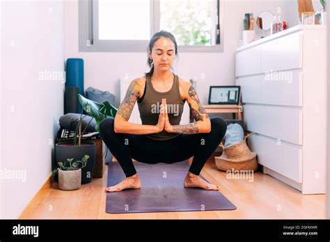 Young Woman Meditating While Doing Yoga At Home Stock Photo Alamy