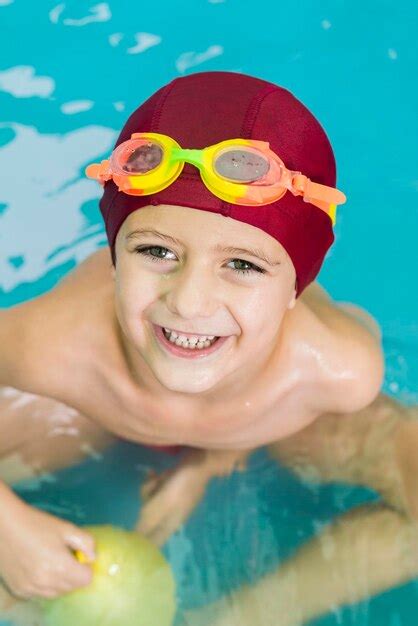 Premium Photo Portrait Of Happy Boy Swimming In Pool