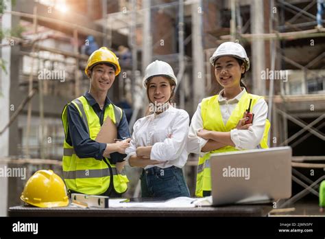 Portrait Group Of Asian Engineers And Architect Working On Site Stock