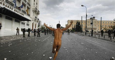 A Naked Man Rolling The World As A Greek Hero