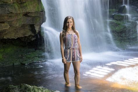 Beautiful Young Woman In Front Of Waterfall Long Exposure Stock Photo