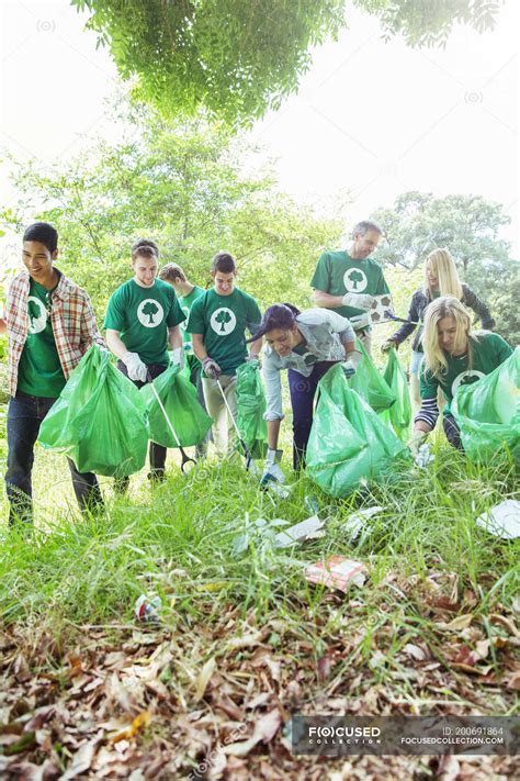 Environmentalist Volunteers Picking Up Trash — Working Preservation