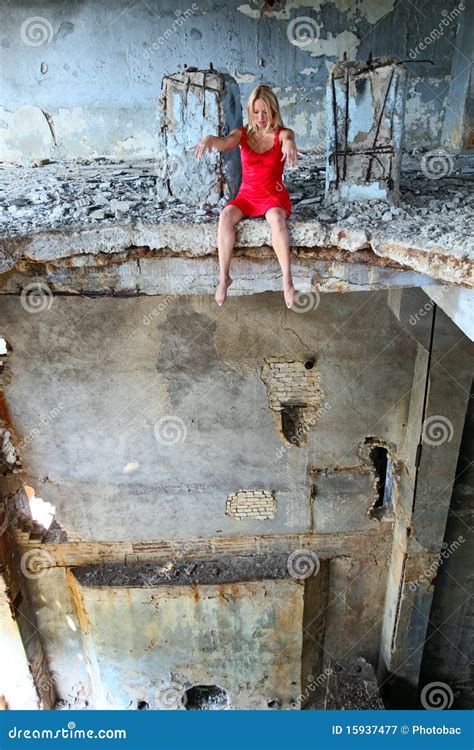 Young Woman Sitting On The Edge In Abandoned Const Royalty Free Stock