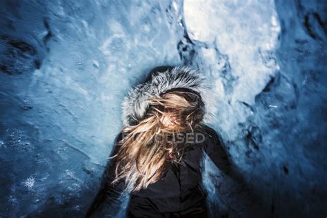 The Woman Is Inside An Ice Cave And Takes A Long Exposure Photograph