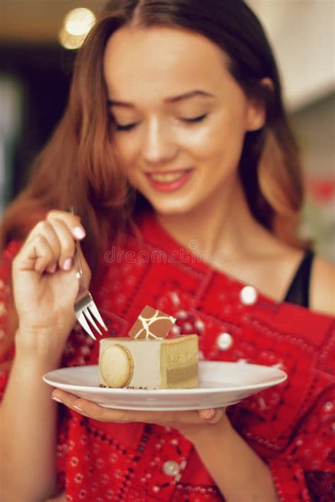 The Girl In The Bakery Eats Dessert Beautiful Model In A Cafe Eats