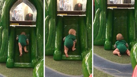 Persistant Baby Struggles To Climb Slide Youtube