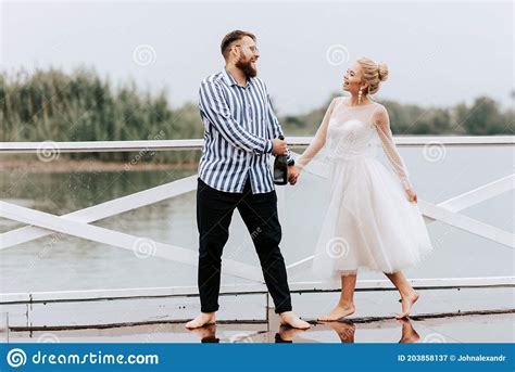 Beautiful Just Married Dance Barefoot And Have Fun On The Pier By The Water Stock Image Image