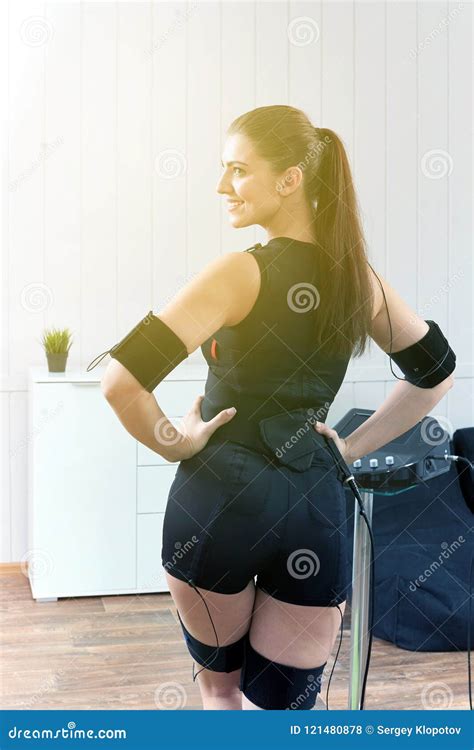 A Beautiful Girl In An Electric Muscular Suit For Stimulation Stock