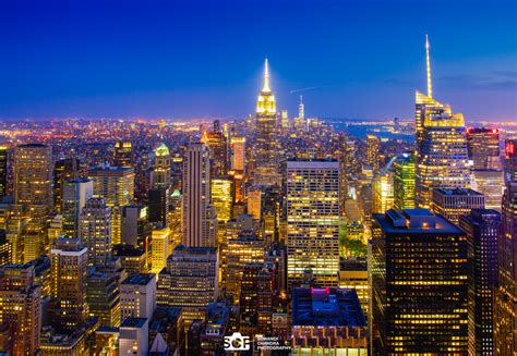 New york city manhattan panorama view at night with office building skyscrapers skyline illuminated over hudson river and two light beam in memory of september 11. New York City Skyline Day & Night | Suwandi Chandra ...