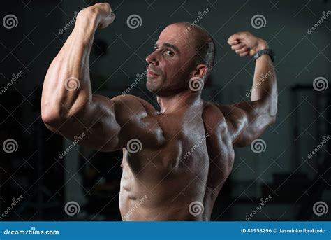 Muscular Man Flexing Back Muscles Pose Stock Photo Image Of Athlete