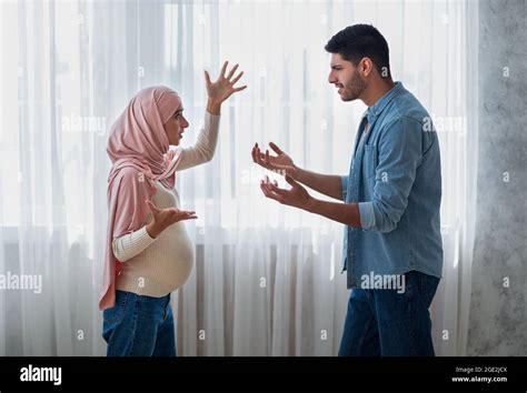 Pregnancy And Relationship Problems Pregnant Arab Woman Arguing With Husband At Home Side View