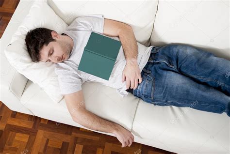 Tired Young Man Sleeping On Couch With Book On Lap — Stock Photo