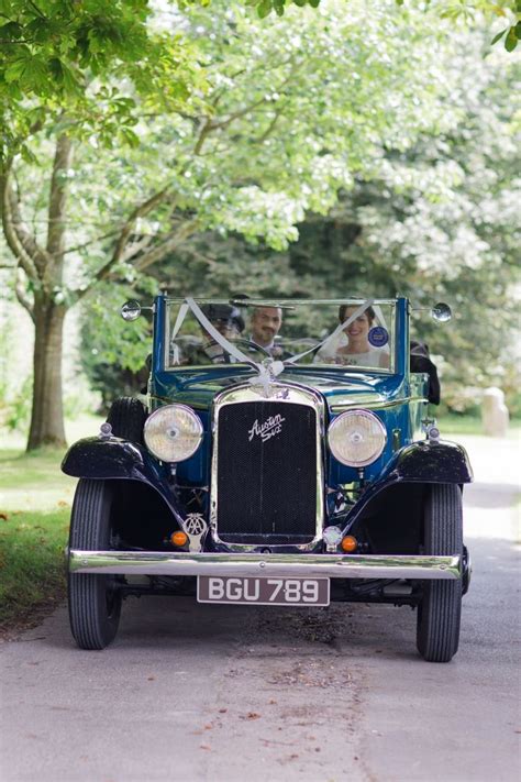 Bride And Groom In Classic Vintage Car Coming Up Drive At Bonhams Barns