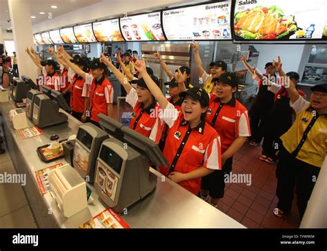 McDonald's employees greet customers with a spirit yell at a new