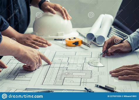 Team Of Architects And Engineer Working On Construction Plans Stock