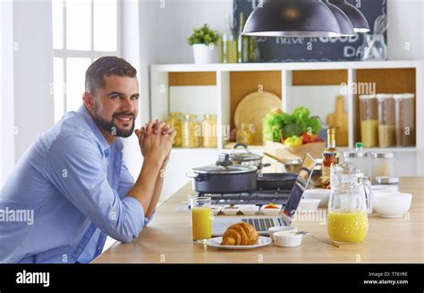 A Business Man Breakfasts With Notebook And Juice Stock Photo Alamy