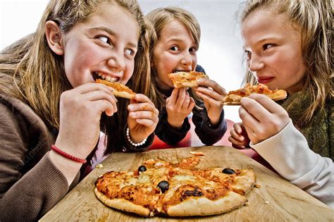 3 Teenagers Eating Pizza Stock Image F0035572 Science Photo Library