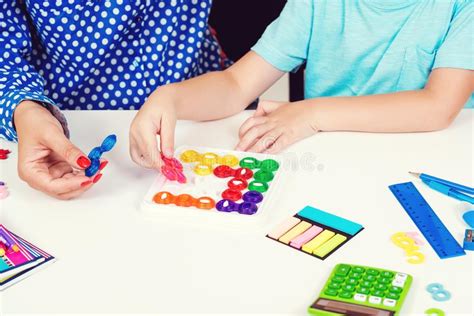 Mother And Kid Plays Logic Game At Table Logical Thinking Training