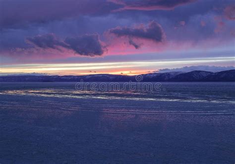 The Frozen Lake Baikal Winter Landscape With Tranparent Ice And Snow