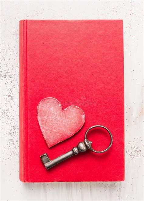 Red Diary Book With Heart And Vintage Key On White Wooden Background
