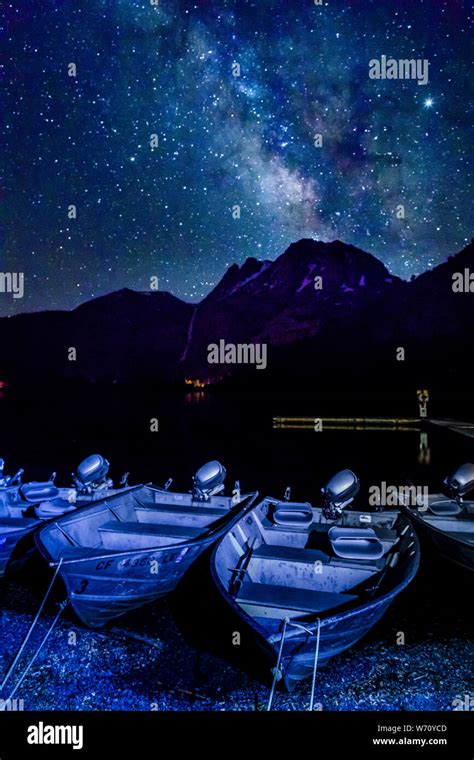 Starry Night Sky With Milky Way Mountains And Boats Stock Photo Alamy