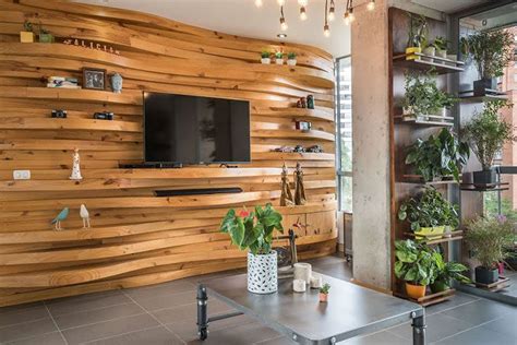 A Wavy Wood Accent Wall Creates Multiple Shelves In This Apartment