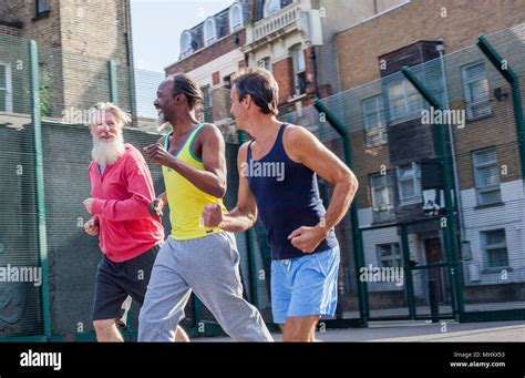 Three Mature Men Outdoors Jogging Stock Photo Alamy
