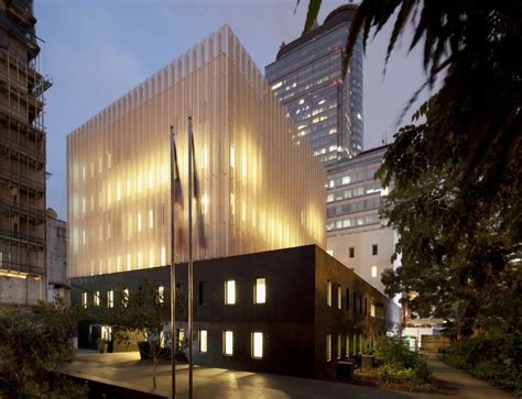 An Office Building Lit Up At Night In The City