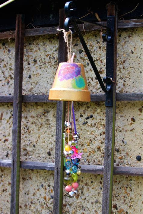 A Lamp That Is On Top Of A Wooden Pole With Beads Hanging From Its Sides