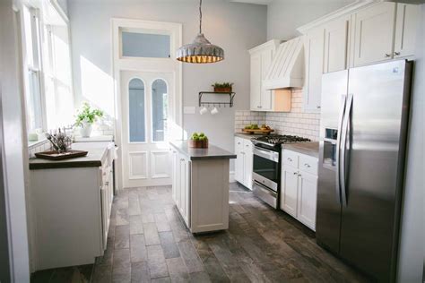 We chose to paint the upper cabinetry white to keep the boldness of the blue from overpowering the kitchen. The Best Fixer Upper Kitchens