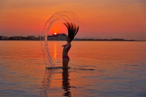 Premium Photo Girl Flipping Hair Flip At Sunset Beach