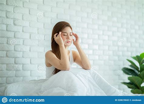 Asian Young Woman Has A Migraine And Headache After Wake Up In Cozy