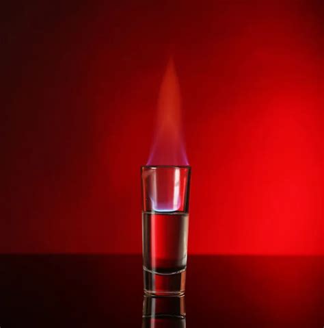 Glass With Burning Alcohol On Red Background Stock Image Everypixel