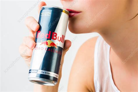 woman drinking red bull stock image c034 3814 science photo library