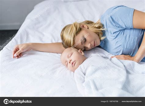 Mother And Baby Sleeping Together Stock Photo Antonlozovoy