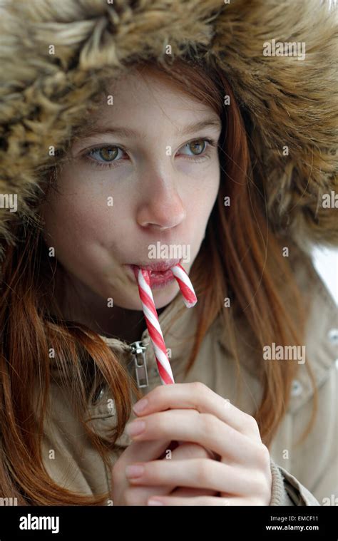Girl Enjoying Candy Cane Stock Photo Alamy