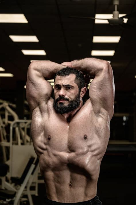 Vacuum Pose Of Strong Young Caucasian Bearded Man Fitness Bodybuilder