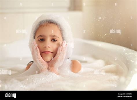 The Girl Bathes And Plays With Foam In The Bathroom It S A Big Drop Blowing Bubbles Stock