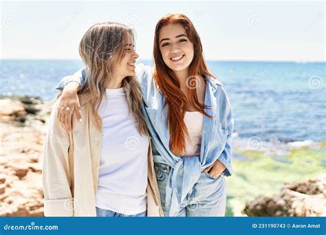 Young Lesbian Couple Of Two Women In Love At The Beach Stock Image