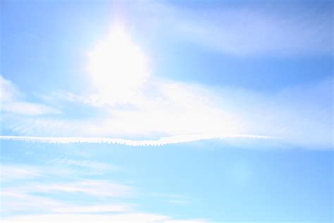 Blue Sky With Sun Clouds And Airplane Trail Picture Free Photograph