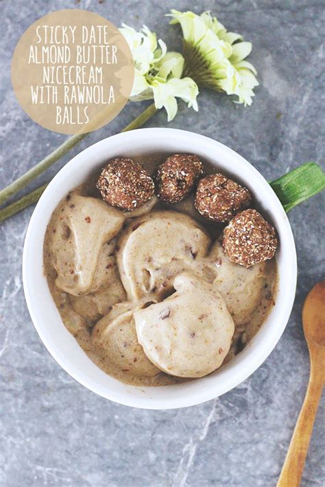 A White Bowl Filled With Food Next To A Wooden Spoon And Flower On The