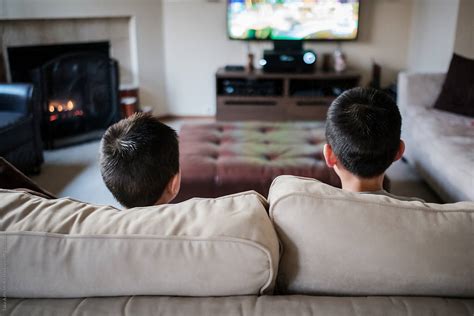 Two Asian Kids Playing Video Game At Home By Stocksy Contributor