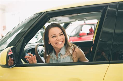 Premium Photo Beautiful Young Woman Buying A Car At Dealership
