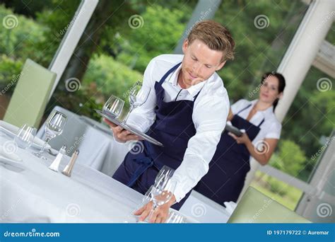 Waiter Setting Table In Restaurant Stock Photo Image Of Cutlery