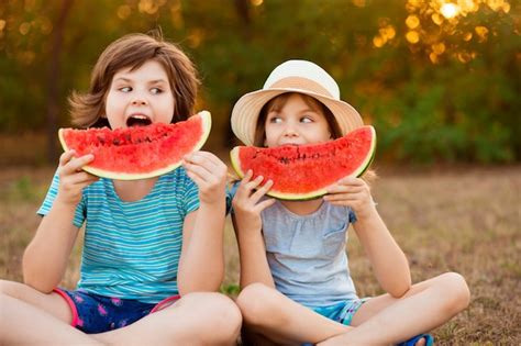 Premium Photo Funny Happy Children Eating Watermelon In Summer Park