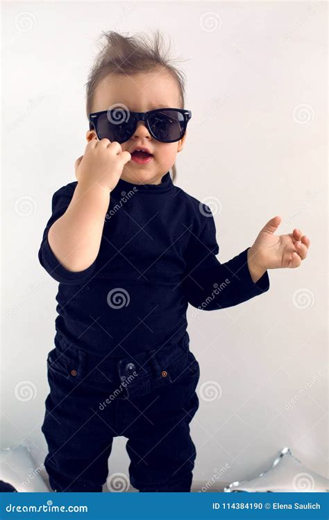 Stylish Baby Boy In Black Rocker Clothes And Sunglasses Stock Photo